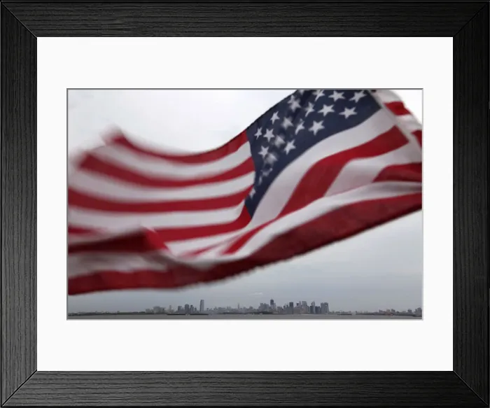 Framed Print : A U. S. flag flutters over top of the skyline of New York and Jersey City Framed Print : A U. S. flag flutters over top of the skyline of New York and Jersey City