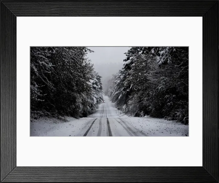 Framed Print : A car travels through a snow covered pine forest near the Basque town of Murgia Framed Print : A car travels through a snow covered pine forest near the Basque town of Murgia