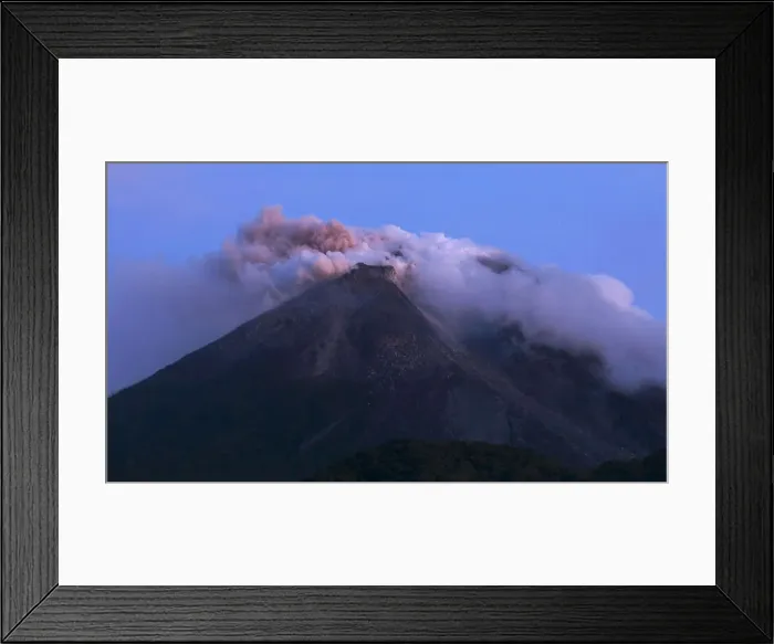 Framed Print : Mount Merapi emits smoke as it is seen from Kali Tengah village near Yogyakarta