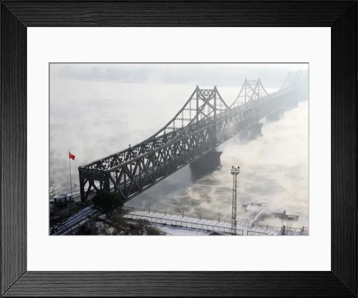 Framed Print : The Friendship Bridge, which connects the Chinese city of Dandong with Sinuiju in North Framed Print : The Friendship Bridge, which connects the Chinese city of Dandong with Sinuiju in North