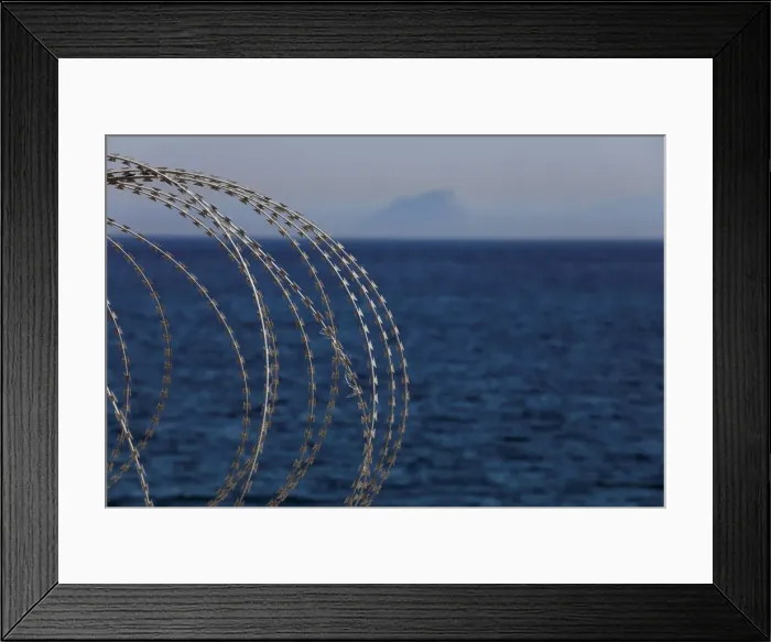 Framed Print : The border fence separating Spains northern enclave Ceuta and Morocco is seen from Ceuta
