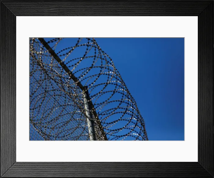 Framed Print : The border fence separating Spains northern enclave Ceuta and Morocco is seen from Ceuta Framed Print : The border fence separating Spains northern enclave Ceuta and Morocco is seen from Ceuta