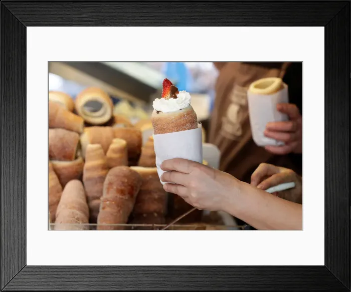 Framed Print : A vendor prepares a traditional Trdelnik sweet pastry in Prague Framed Print : A vendor prepares a traditional Trdelnik sweet pastry in Prague