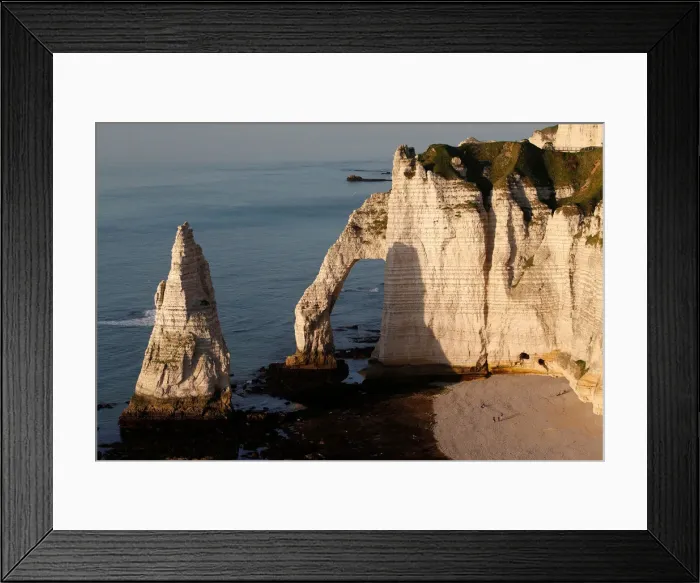 Framed Print : The Porte d Aval, a famous arch of the Etretats cliffs, is seen during sunset Framed Print : The Porte d Aval, a famous arch of the Etretats cliffs, is seen during sunset