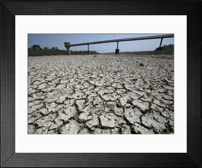 Framed Print : A water pump shed is seen in the dried-up portion of the Sabarmati river on a hot day Framed Print : A water pump shed is seen in the dried-up portion of the Sabarmati river on a hot day