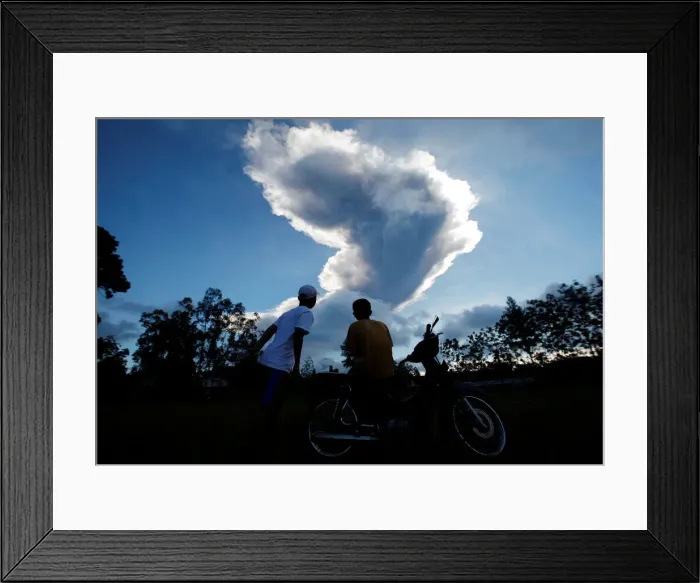 Framed Print : People watch as Mount Merapi volcano erupts from Purwobinangun Village, near Yogyakarta Framed Print : People watch as Mount Merapi volcano erupts from Purwobinangun Village, near Yogyakarta