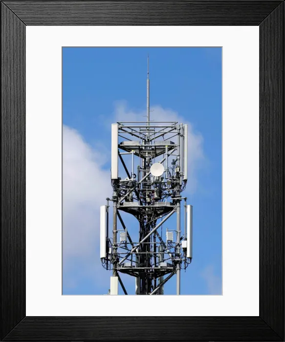 Framed Print : Mobile telecom transmitter relays and antenna are seen on the roof of a building in