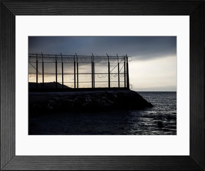 Framed Print : The border fence separating Spains northern enclave Ceuta and Morocco is seen from Ceuta Framed Print : The border fence separating Spains northern enclave Ceuta and Morocco is seen from Ceuta