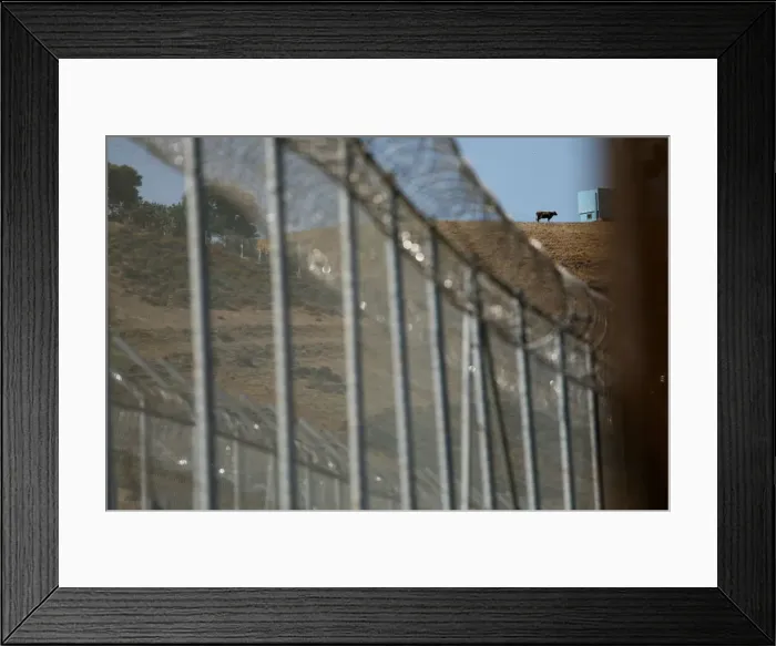 Framed Print : The border fence separating Spains northern enclave Ceuta and Morocco is seen from Ceuta