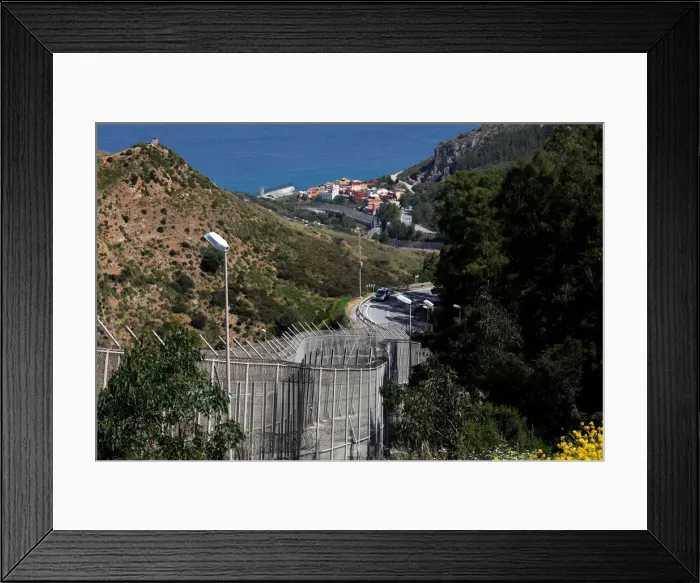 Framed Print : The border fence separating Spains northern enclave Ceuta and Morocco is seen from Ceuta