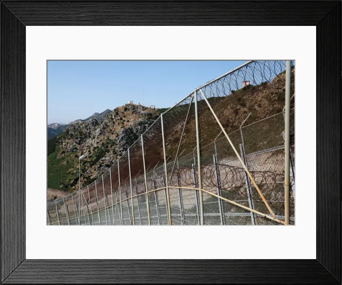 Framed Print : The border fence separating Spains northern enclave Ceuta and Morocco is seen from Ceuta Framed Print : The border fence separating Spains northern enclave Ceuta and Morocco is seen from Ceuta