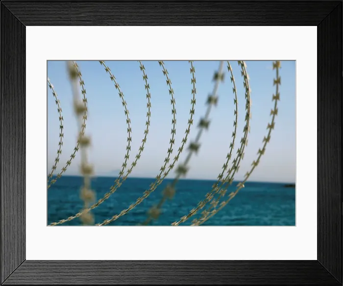 Framed Print : The border fence separating Spains northern enclave Ceuta and Morocco is seen from Ceuta