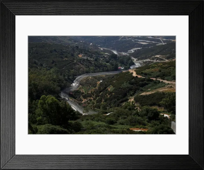 Framed Print : The border fence separating Spains northern enclave Ceuta and Morocco is seen from Ceuta Framed Print : The border fence separating Spains northern enclave Ceuta and Morocco is seen from Ceuta