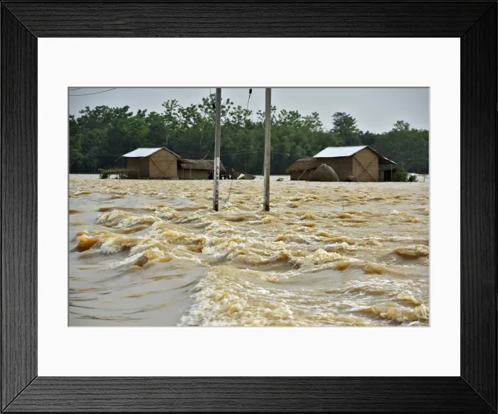 Framed Print : Partially submerged houses are seen at a flood-affected village in Hojai district