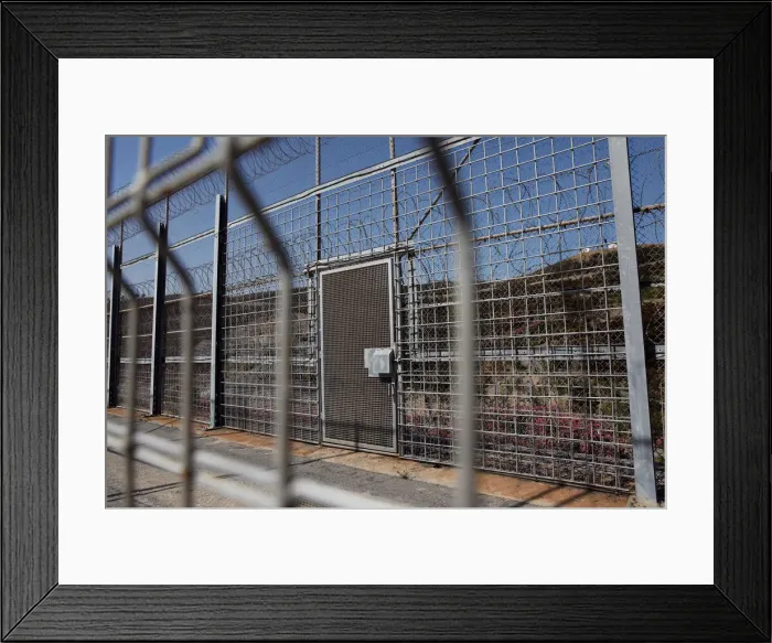 Framed Print : The border fence separating Spains northern enclave Ceuta and Morocco is seen from Ceuta
