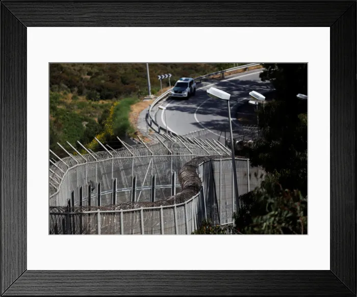 Framed Print : The border fence separating Spains northern enclave Ceuta and Morocco is seen from Ceuta Framed Print : The border fence separating Spains northern enclave Ceuta and Morocco is seen from Ceuta