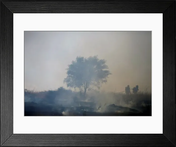 Framed Print : Firefighters try to extinguish fire on the Israeli side of the border fence between Framed Print : Firefighters try to extinguish fire on the Israeli side of the border fence between
