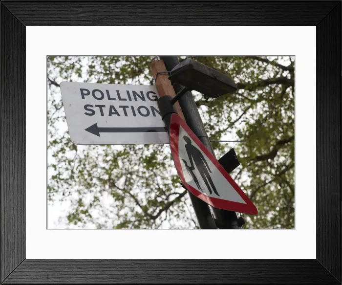 Framed Print : A polling station sign is attached to a lamp post in central London Framed Print : A polling station sign is attached to a lamp post in central London