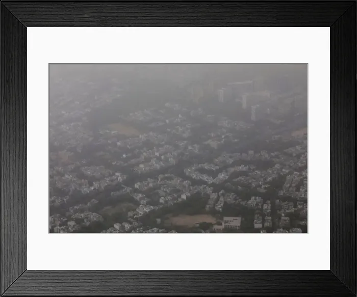 Framed Print : Buildings are seen blanketed by haze and dust on the outskirts of New Delhi Framed Print : Buildings are seen blanketed by haze and dust on the outskirts of New Delhi