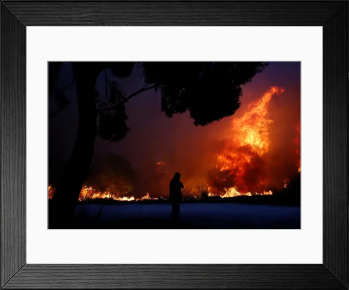 Framed Print : A man looks at the flames as a wildfire burns in the town of Rafina Framed Print : A man looks at the flames as a wildfire burns in the town of Rafina