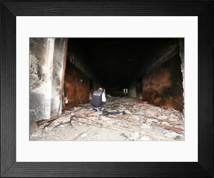 Framed Print : Security personnel inspects the site of a suicide attack on the electoral commission in Framed Print : Security personnel inspects the site of a suicide attack on the electoral commission in