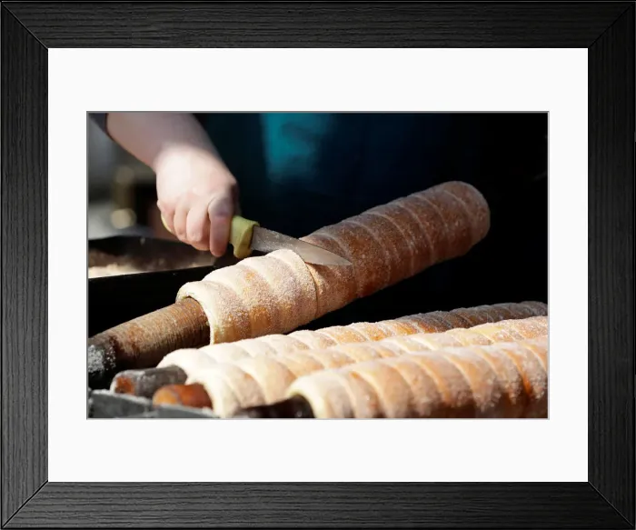 Framed Print : A vendor prepares a traditional Trdelnik sweet pastry in Prague Framed Print : A vendor prepares a traditional Trdelnik sweet pastry in Prague