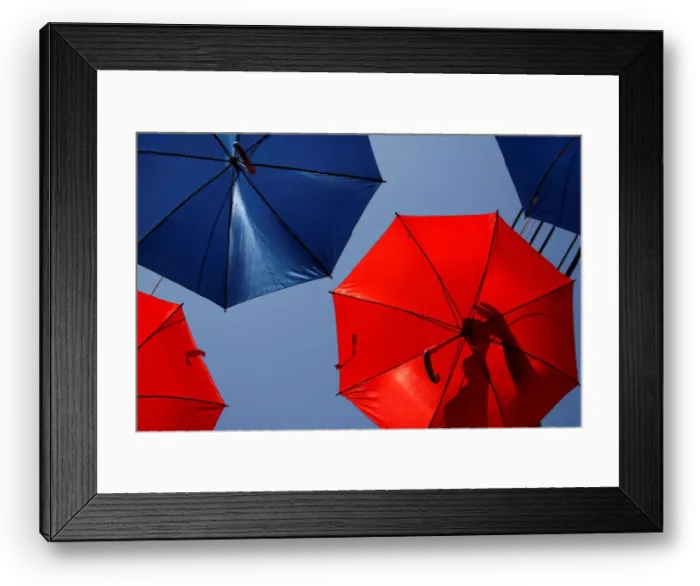 Framed Print : A worker arranges coloured umbrellas hanging over a street in preparation for a music Framed Print : A worker arranges coloured umbrellas hanging over a street in preparation for a music
