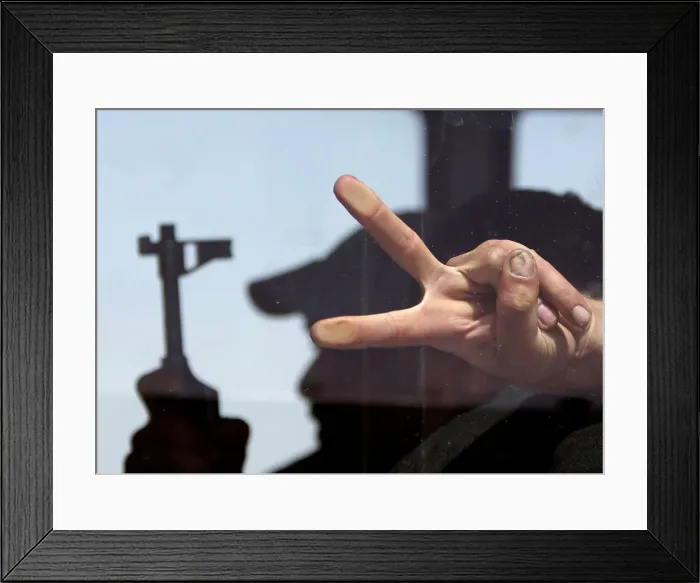 Framed Print : A rebel fighter gestures as he sits inside a bus during evacuation Framed Print : A rebel fighter gestures as he sits inside a bus during evacuation