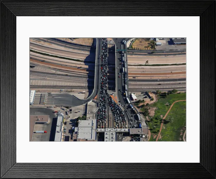 Framed Print : Automobiles pass through the U. S. border and into the United States from Juarez