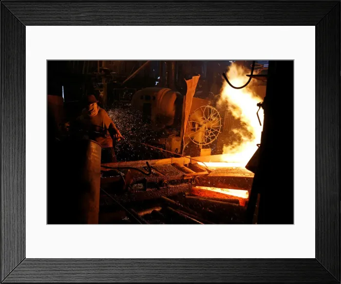 Framed Print : A steelworker is seen in a mill in Chau Khe village outside Hanoi