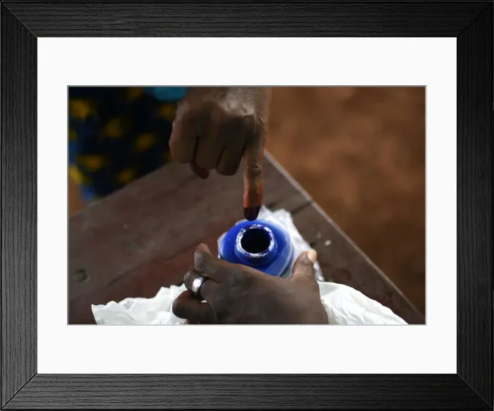 Framed Print : A voters finger is marked with ink at a polling station during a presidential run-off in Framed Print : A voters finger is marked with ink at a polling station during a presidential run-off in