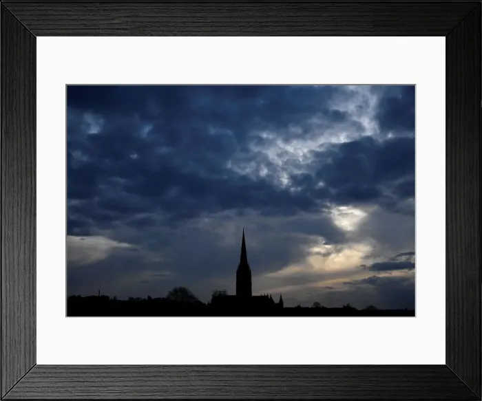 Framed Print : The afternoon sun pierces clouds behind Salisbury Cathedral Framed Print : The afternoon sun pierces clouds behind Salisbury Cathedral