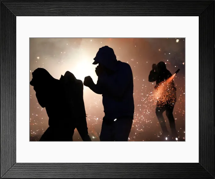Framed Print : People enjoy fireworks exploding from a traditional bull figure known as El Torito in Framed Print : People enjoy fireworks exploding from a traditional bull figure known as El Torito in