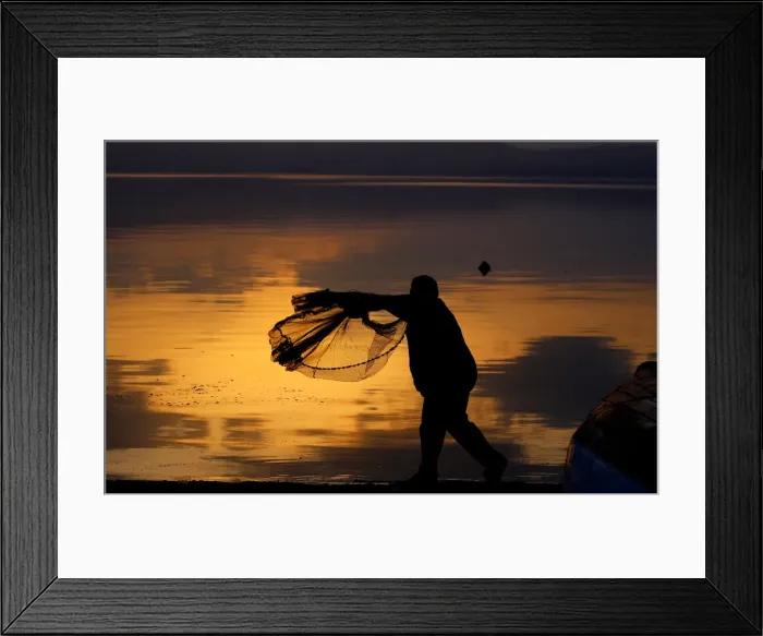 Framed Print : A fisherman uses his net at Lake Ohrid in Ohrid