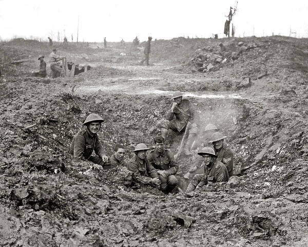 British soldiers sheltering in shell hole, Western Front, WW
