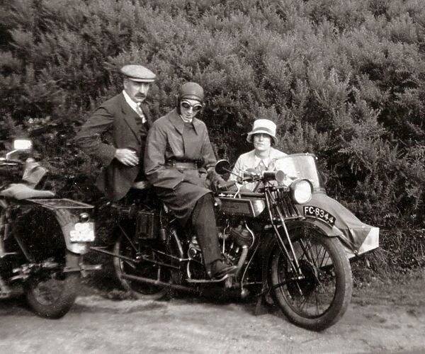 Gentlemen & lady on vintage motorcycle combination at roadsi