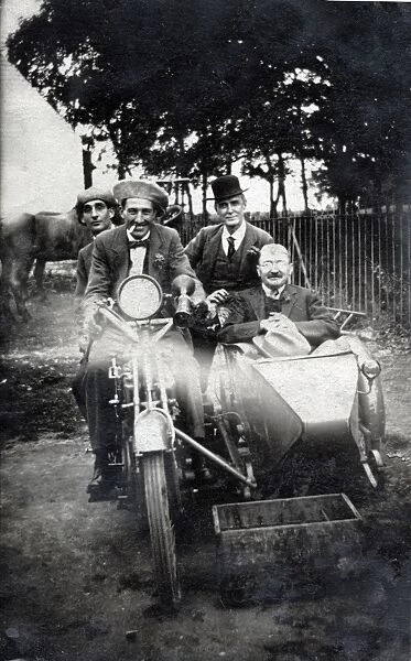 Four men sitting on vintage motorcycle and in sidecar