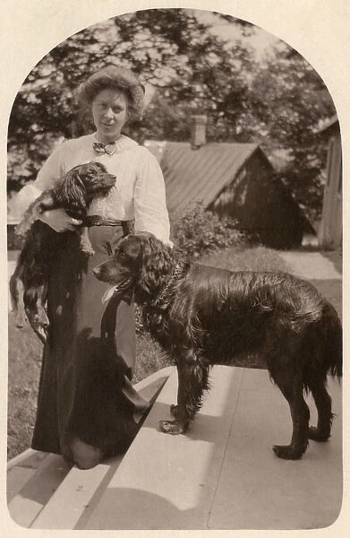 Woman with two dogs in a garden, Finland