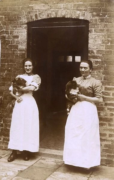 Two women with Pekingese dogs