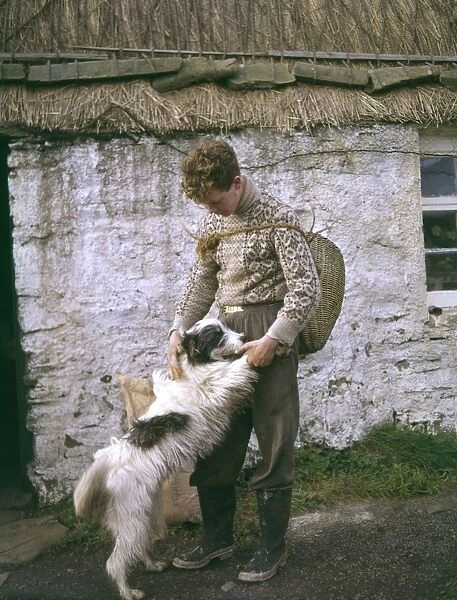 Young crofter with his dog, Shetland, Scotland