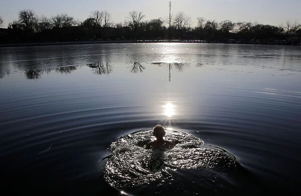 An 89-year-old resident swims in Houhai lake in central Beijing