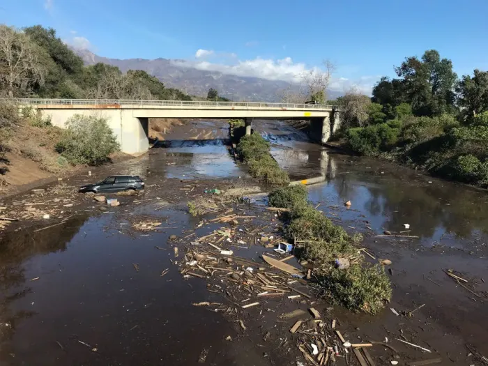 Framed Print : An abandoned car is seen stuck in flooded water on the 101 freeway after a mudslide in Framed Print : An abandoned car is seen stuck in flooded water on the 101 freeway after a mudslide in