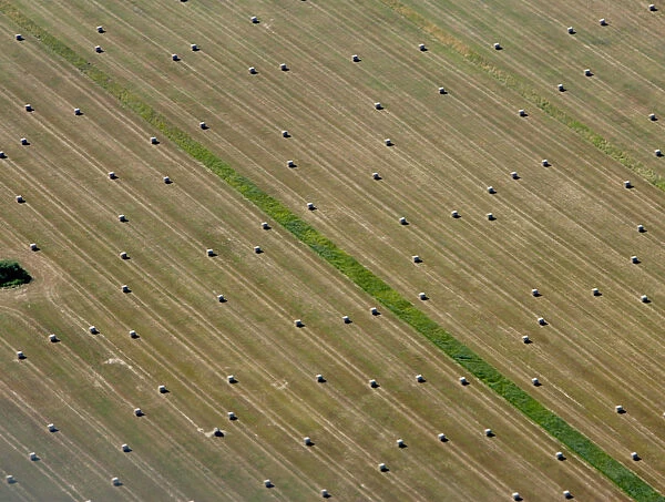 Aerial view of bales of straw on a harvested grain field in Brandenburg state