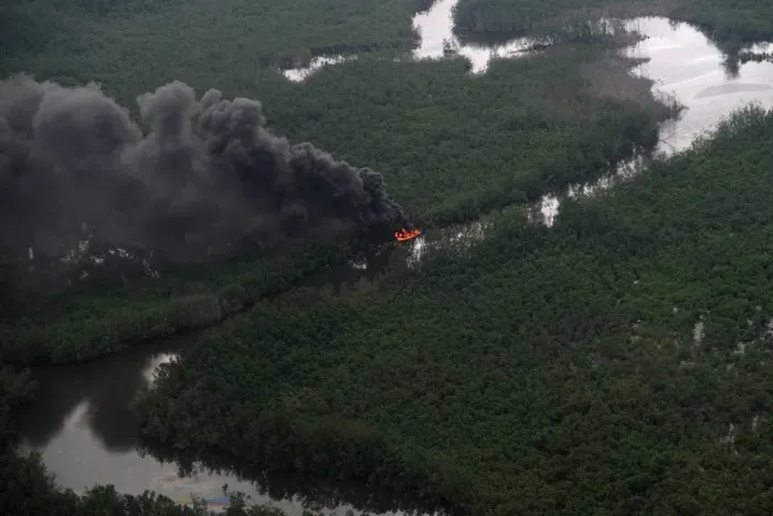 Framed Print : An aerial view of a boat burning in the waterways of the Niger Delta in Rivers State Framed Print : An aerial view of a boat burning in the waterways of the Niger Delta in Rivers State