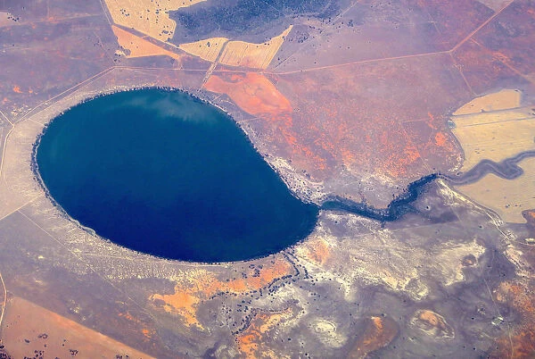 An aerial view of a large lake surrounded by agricultural farming land in south-western