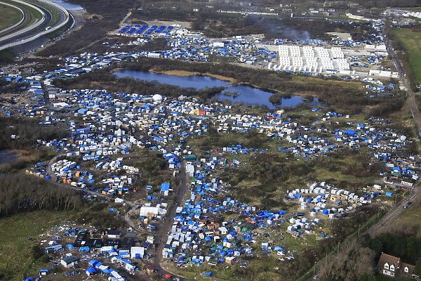 Aerial view of a makeshift camp as containers are put into place to house several hundred
