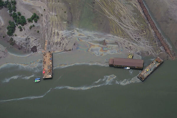 An aerial view shows boats and barges used to help plug an oil leak in the waterways of