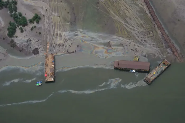 Framed Print : An aerial view shows boats and barges used to help plug an oil leak in the waterways of