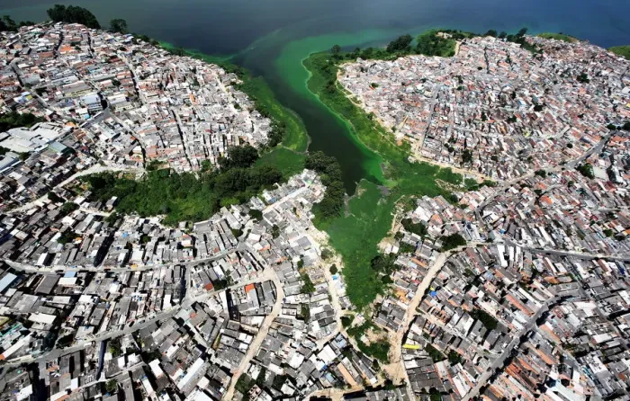 Framed Print : An aerial view shows illegally built slums on the border of the polluted water of Framed Print : An aerial view shows illegally built slums on the border of the polluted water of