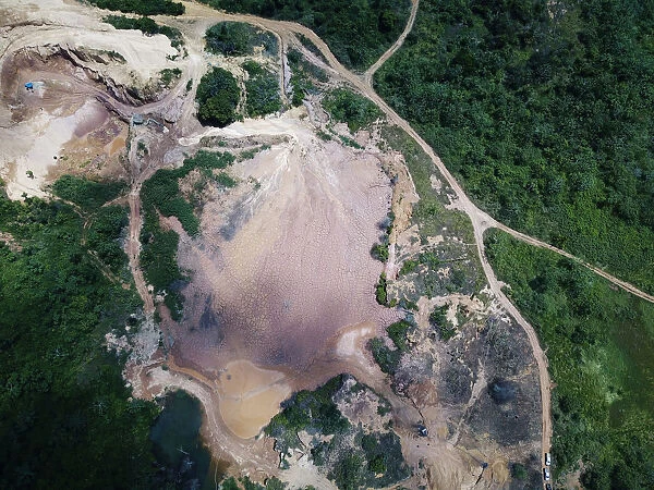An aerial view shows the location of an illegal gold mine as its machines are destroyed